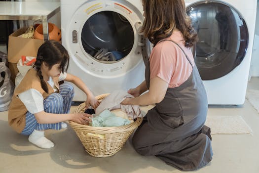 pexels-photo-7943538-7943538 A mother and daughter sorting laundry together in a cozy home setting.